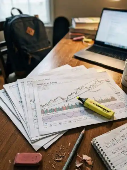 Value Line investment survey stock charts printed on a study desk
