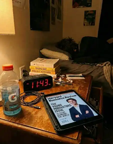 Harvard Business Review magazine on a tablet screen next to a bed