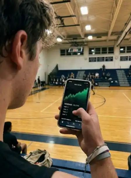 Teen holding smartphone showing a custodial brokerage account stock chart